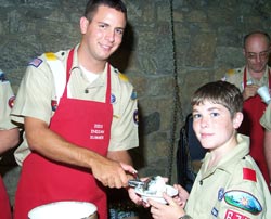 National chief serves ice cream to a young Arrowman