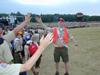 An OA Service corps usher greets Scouts as they enter the arena