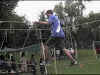 A scout testing his balance skills on the rope bridge